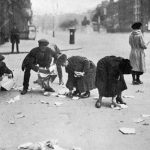 People in O’Connell Street collect scraps from the aftermath of the explosion in the PROI in 1922.