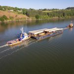 Aerial view of the GPS Avenger tugboat, assisted by tug Dutch Power, towing a barge carrying bridge spans for Waterford’s Sustainable Transport Bridge.